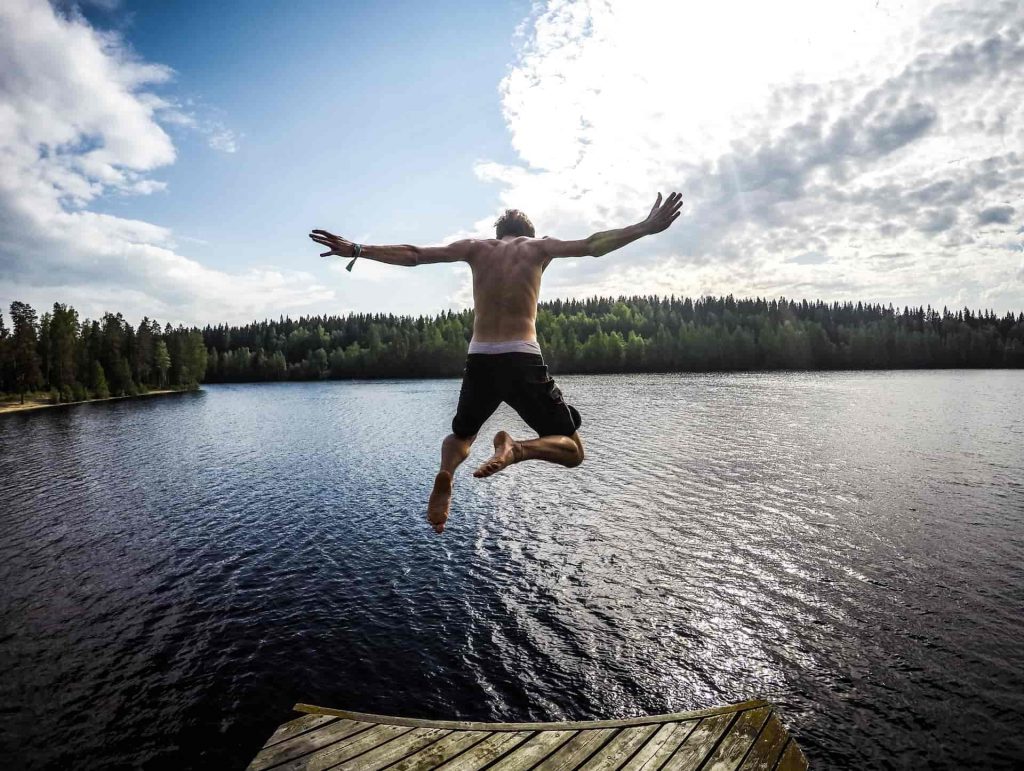 man jumping into lake. 30 days wild ideas