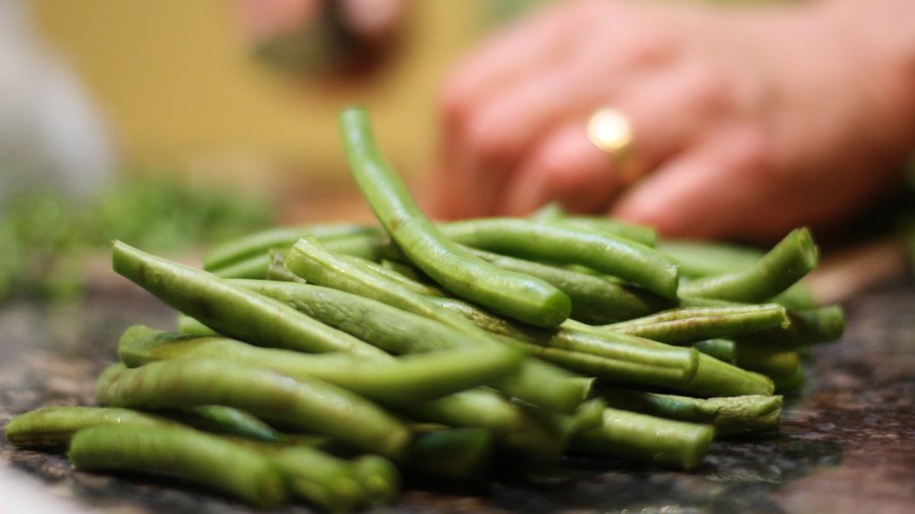 person chopping French beans, whicb are in season in the UK in June