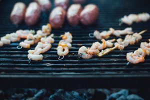 king prawn skewers cooking on a BBQ grill