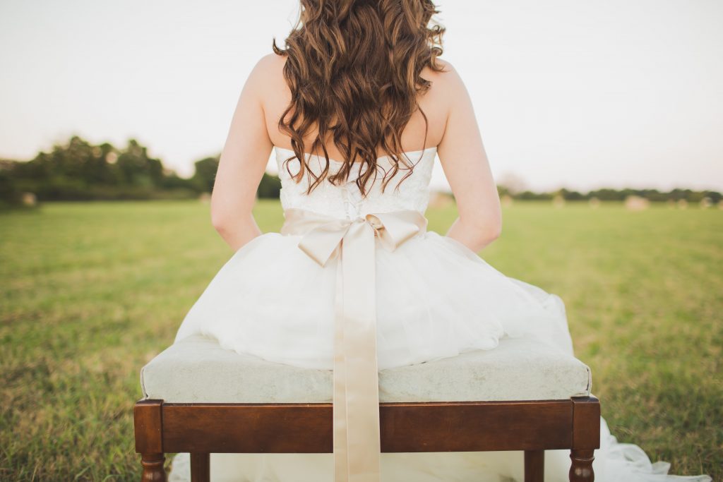  bride sitting with her back to camera on a bench