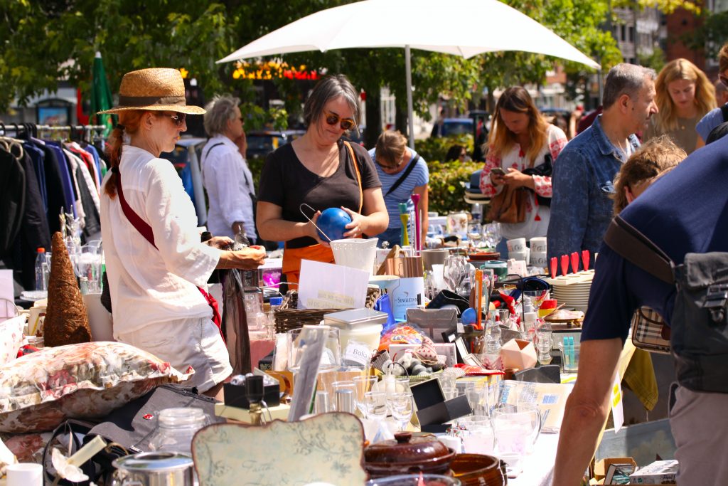 people milling about at a community yard sale