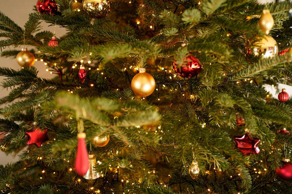real christmas tree decorated with baubles