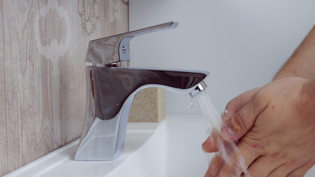 exfoliating coffee grounds bar by the sink, with someone washing their hands