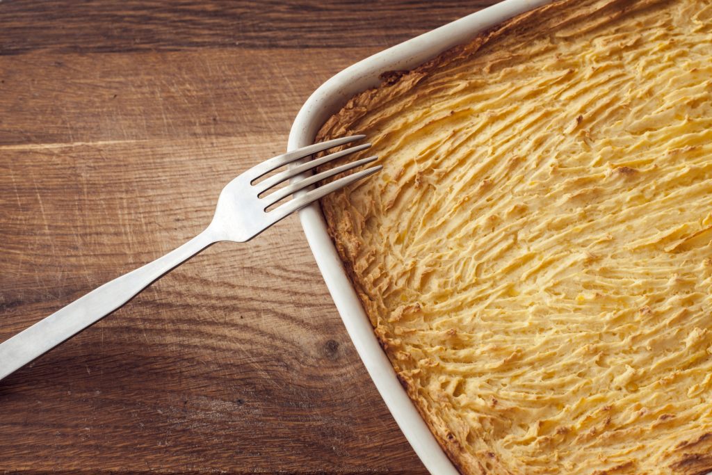 meat-free shepherd's pie with a fork resting on the side of a white dish
