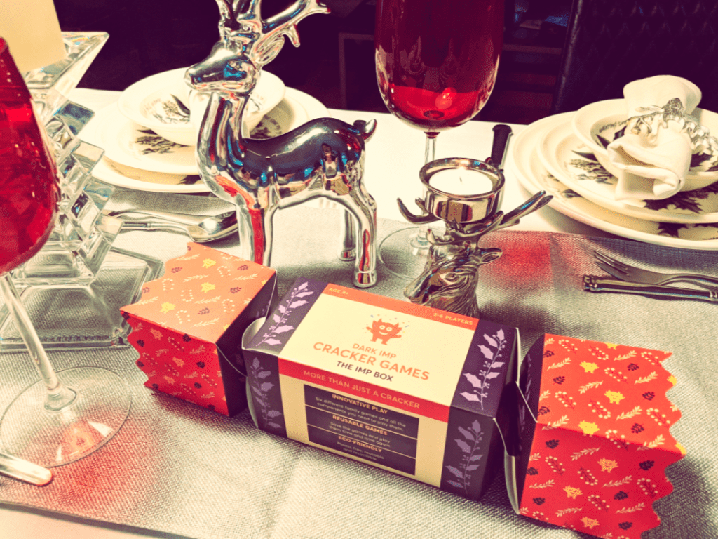 The dark imp's reusable eco-friendly  family Christmas cracker sits on a festive table