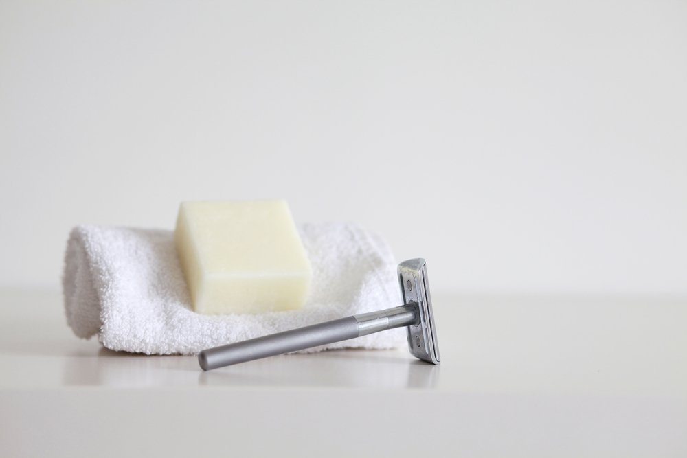 sustainable shaving equipment: metal safetry razor, solid soap and a washcloth